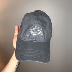 Light gray hat with “Adventure” logo